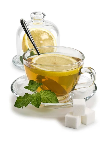 Green tea, lemon, mint and sugar in glassware it is isolated on white