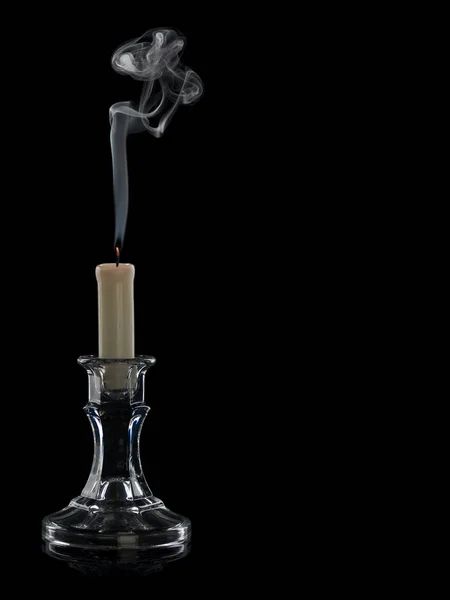 Smoke from the extinguished candle in a glass candlestick it is isolated on the black