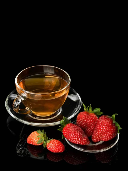 Green tea with strawberry in glassware