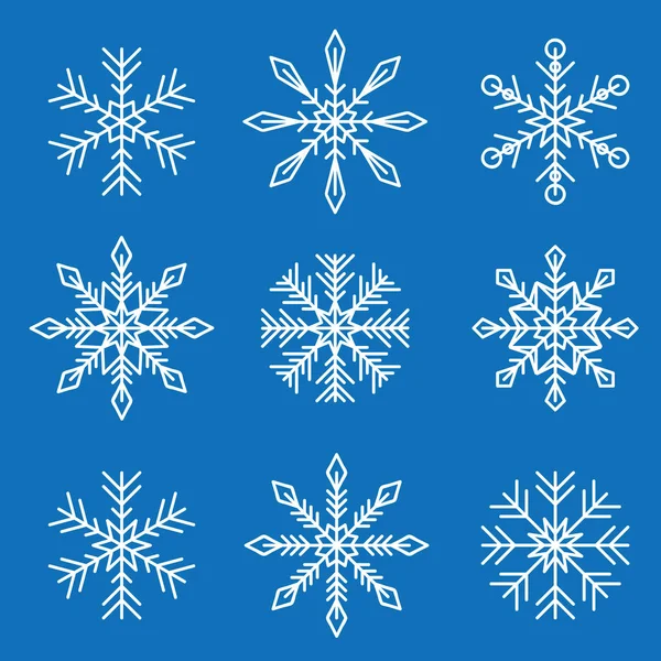 Conjunto de diferentes copos de nieve blancos aislados sobre fondo azul — Vector de stock