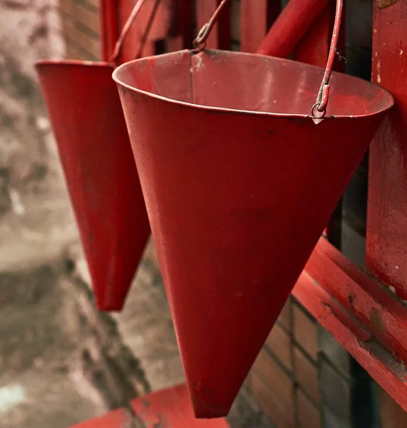 red conical fire bucket