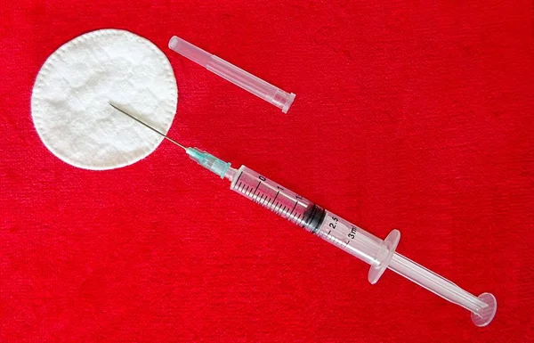 Medicine Medical Health Industry Transparent Plastic Syringe For Drugs Medicament Vaccine Injection Tool And White Cotton Circles On The Red Textile Cloth Velvet Background