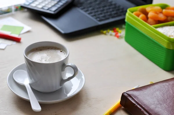Food in the office or at school. Lunch box with healthy food and a Cup of coffee on the desktop.