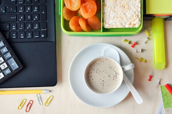 Food in the office or at school. Lunch box with healthy food and a Cup of coffee on the desktop. top view.