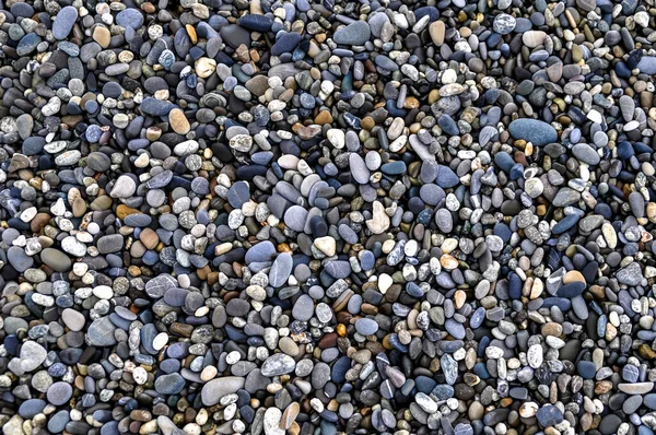 Hintergrund von glatten schönen Steinen am Strand nach einem Sturm für den Urlaub, — Stockfoto