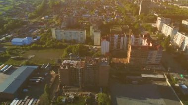 Güneşli bir günde, yeni inşa edilmiş banliyölerin sokaklarında ve genç ağaçlarla kaplı hava uçuşları. 4k.