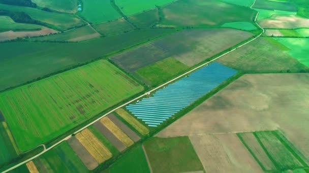 Vista aérea do drone da grande fazenda solar nos campos verdes. Zoom. 4K . — Vídeo de Stock