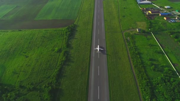 Aerial following view of white plane launching from take off runaway in the air. 4K. — Stock Video