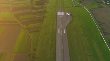 Kalkış hattını çeviren küçük bir uçağın havadan görünümü veya kuş bakışı görünümü. 4k.