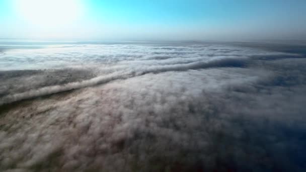 Luchtfoto nadert van dichte pluizige wolken naar de stad overhead weergeven bij zonsopgang. — Stockvideo