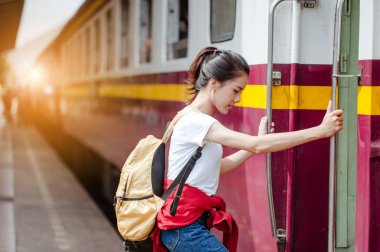 Gezgin kadın trene biniyor.