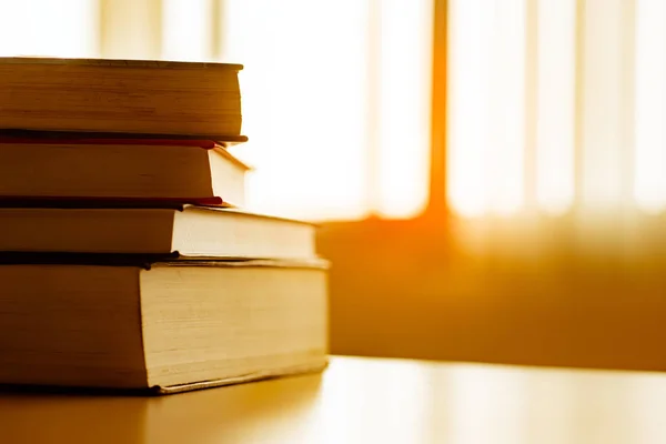 Book stack is placed on the library desk. education background, back to school concept.