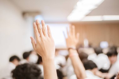  Seminer sırasında iş adamı elini kaldırıyor. İş Adamı Bir Konferansta Soruya Cevap Vermek İçin Elini Kaldırıyor.