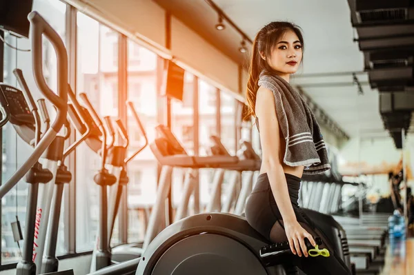 young fitness woman tired in gym drink   protein shake.exercising concept.fitness and healthy lifestyle