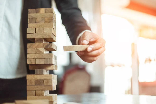 Uomo Affari Mano Tirando Fuori Mettendo Blocco Legno Sulla Torre — Foto Stock