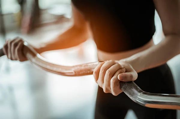 Genç Fitness Asyalı kadın spor salonunda kaslarını geliştirmek için halterlerle egzersiz yapıyor. Egzersiz yapıyor. Fitness ve sağlıklı yaşam tarzı. 
