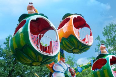 Mavi gökyüzü arka plan üzerinde lunaparktaki çocuk atlıkarınca.