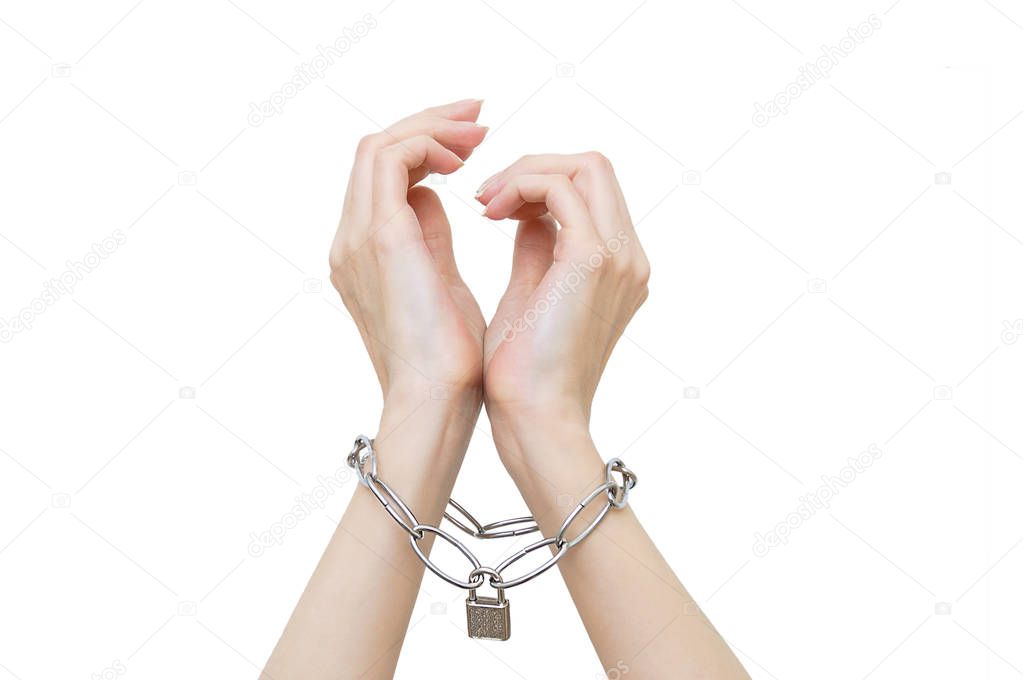 Women's hands are chained and locked. White isolate.