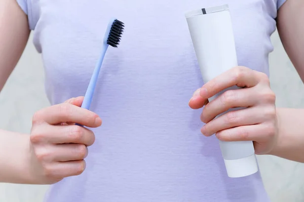 Close Van Een Tandenborstel Plak Handen Van Een Blanke Vrouw — Stockfoto