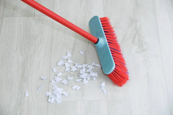 Sweep the floor with a brush. Indoor cleaning close-up.