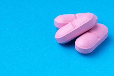 mavi arka planda pembe haplar. omega3. Vitamin.