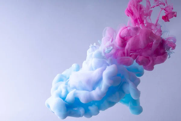 물에 소용돌이 치는 다채로운 잉크. 흰색 배경에 부드러운 잉크 구름. — 스톡 사진