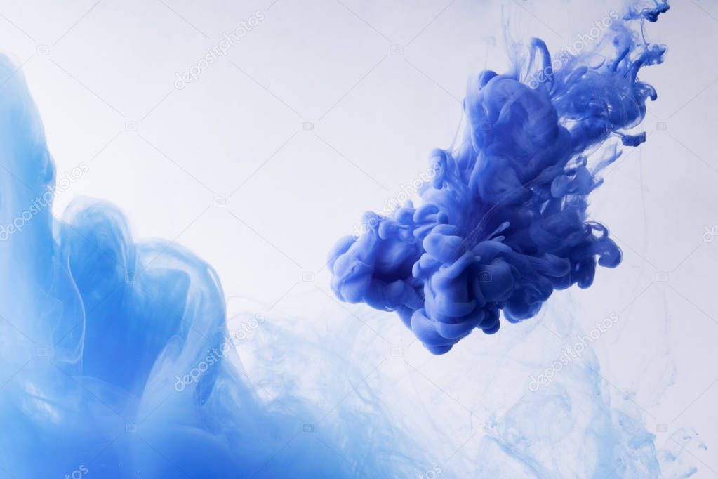 Colorful Ink swirling in water. Cloud of silky ink on white background.