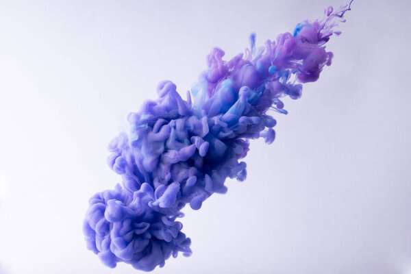 Colorful Ink swirling in water. Cloud of silky ink on white background.