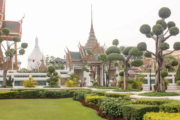 Vacker trädgård som leder till templet i Royal Grand Palace. Bangkok, Thailand. — Stockfoto