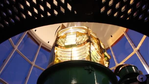 Close up of beautiful golden Fresnel lens inside Lighthouse, with gorgeous lights and shadows as lamp rotates. — Stock Video