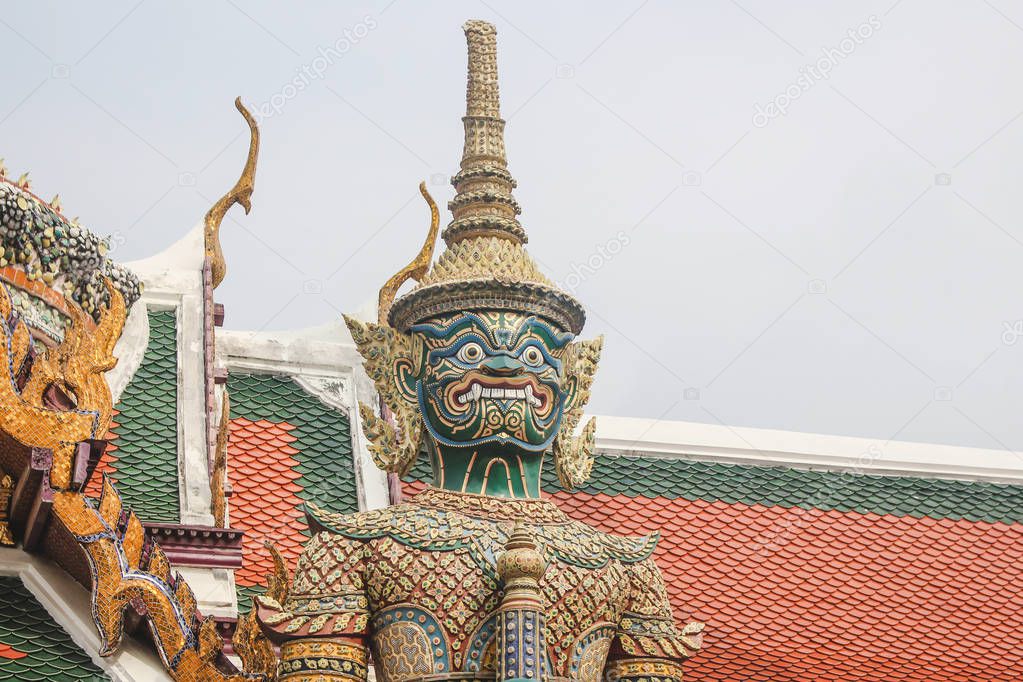 Intricately detailed giant demon guardian statue, known as Thotsakhirithon, in Wat Phra Kaew temple. Bangkok, Thailand.