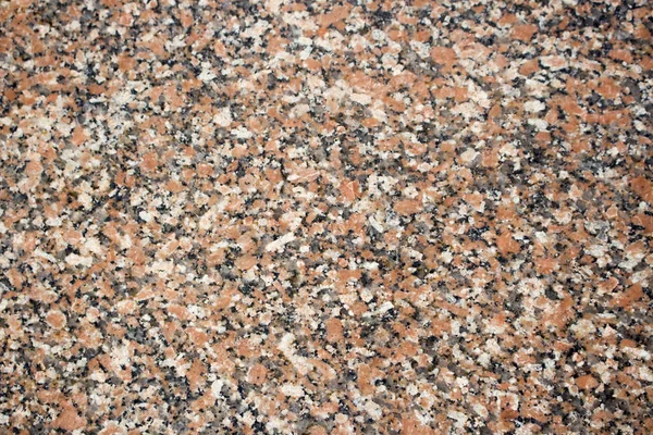 Maple Leaf rode graniet stenen achtergrond. Gevlekte rode en zwarte gekleurde graniet textuur. — Stockfoto
