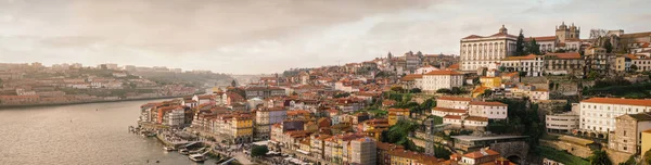 Sepia tone panoramic shot of the Porto skyline, overseeing the Ribeira area and the Douro River.