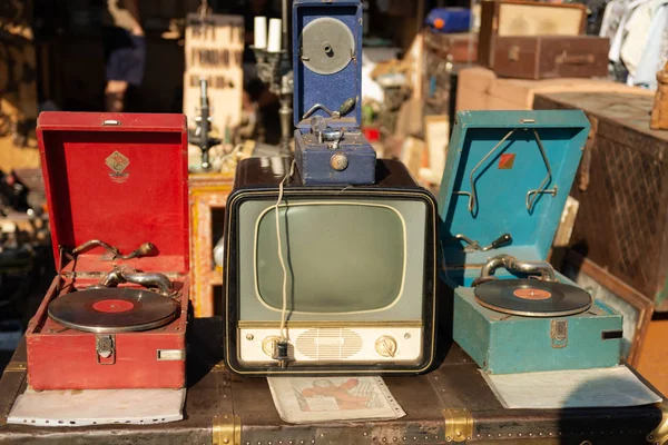 Flea market. Sale of old things. Record players and the first TV set.