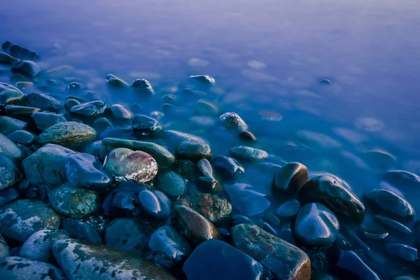 Mystical blue stones. Stones of the blue coast. Twilight at sea. Twilight and stones. Stones and water. Blue water and stones.