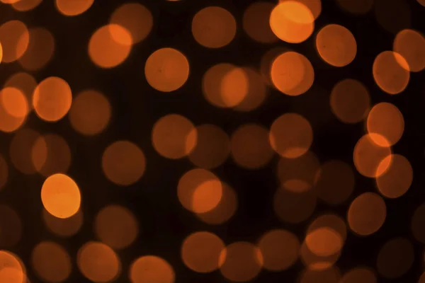 Hollywood bokeh arka plan. Turuncu siyah bir arka plan üzerinde daireler.