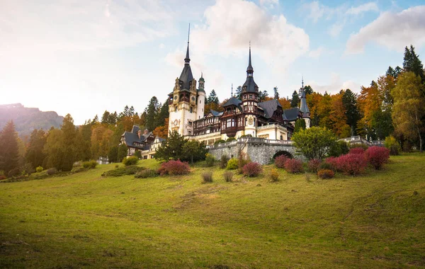 Panorama of Peles Castle, Romania. Beautiful famous royal castle and ornamental garden in Sinaia landmark of Carpathian Mountains in Europe at sunset. Former Home Of The Romanian Royal Family.