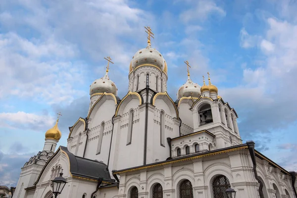 Zachatyevsky Monastery Katholikon in Ostozhenka district, Moscow, Russia. Nativity of Virgin Mary Cathedral. Orthodox church and blue cloudy sky.