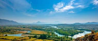 Aerial panorama view of the Buna River after the confluence with the Drin River from Rozafa Castle, Shkoder, Albania. Meandres and mountain. Beautiful Landscape clipart