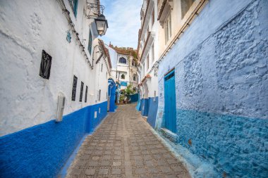 Mavi şehrin güzel manzarası CheFCHAOUEN, Medina 'daki MoroCCO. Geleneksel Fas mimari detayları ve boyalı evler. Kapısı olan bir sokak ve kemerli parlak mavi duvarlar