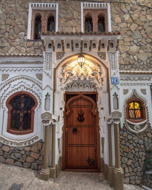 Tipik, eski, karmaşık bir şekilde oyulmuş, çivili, Faslı kapı ve çerçeve ve CheFCHAOUEN, Fas 'taki eski ev. Medine 'deki mavi şehrin güzel manzarası. boyanmış evler