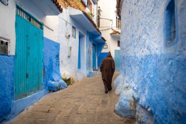 Mavi şehrin güzel manzarası CheFCHAOUEN, Medina 'daki MoroCCO. Geleneksel Fas mimari detayları ve boyalı evler. Kapısı olan bir sokak ve kemerli parlak mavi duvarlar