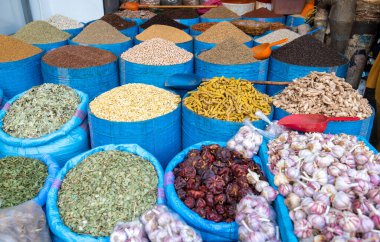 Piles of traditional spices in souk, market in medina of Marrakech, Morocco. Selection of herbs and dry flowers and fruits. Colorful, sold on street bazaar clipart