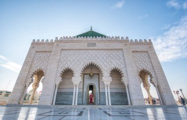 Rabat, Morocco - 21 August, 2019: The Mausoleum of Mohammed V is a historical building located on the opposite side of the Hassan Tower on the Yacoub al-Mansour esplanade and guard on the door clipart