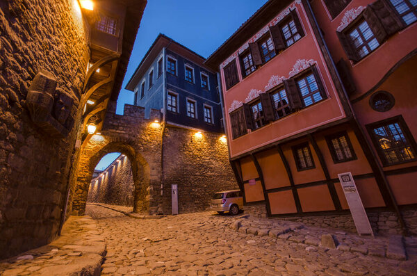 PLOVDIV, BULGARIA. Night photo of houses and street under ancient fortress entrance of old town of city of Plovdiv, Bulgaria - European capital of culture 2019