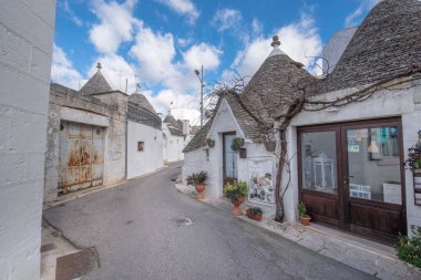 ALBEROBELLO, PUGLIA, ITALY - 14 Mart 2019: Alberobello 'nun ünlü Trulli' sinin panoramik görünümü, Itria Vadisi, Apulia, Güney İtalya 'nın karakteristik koni beyaz evler. 