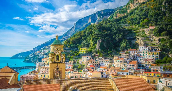 Mavi deniz ve bulutlu gökyüzü ile Amalfi 'nin ve katedralin manzarası. İtalya 'nın Positano kenti yakınlarındaki renkli evler ve Akdeniz manzarası çok güzel..