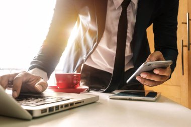 işadamı el akıllı telefon, tablet ödemeler ve holding kredi kartı kullanma online alışveriş, omni kanal, dijital tablet klavye bilgisayar Bürosu'nda güneş ışığı yerleştirme