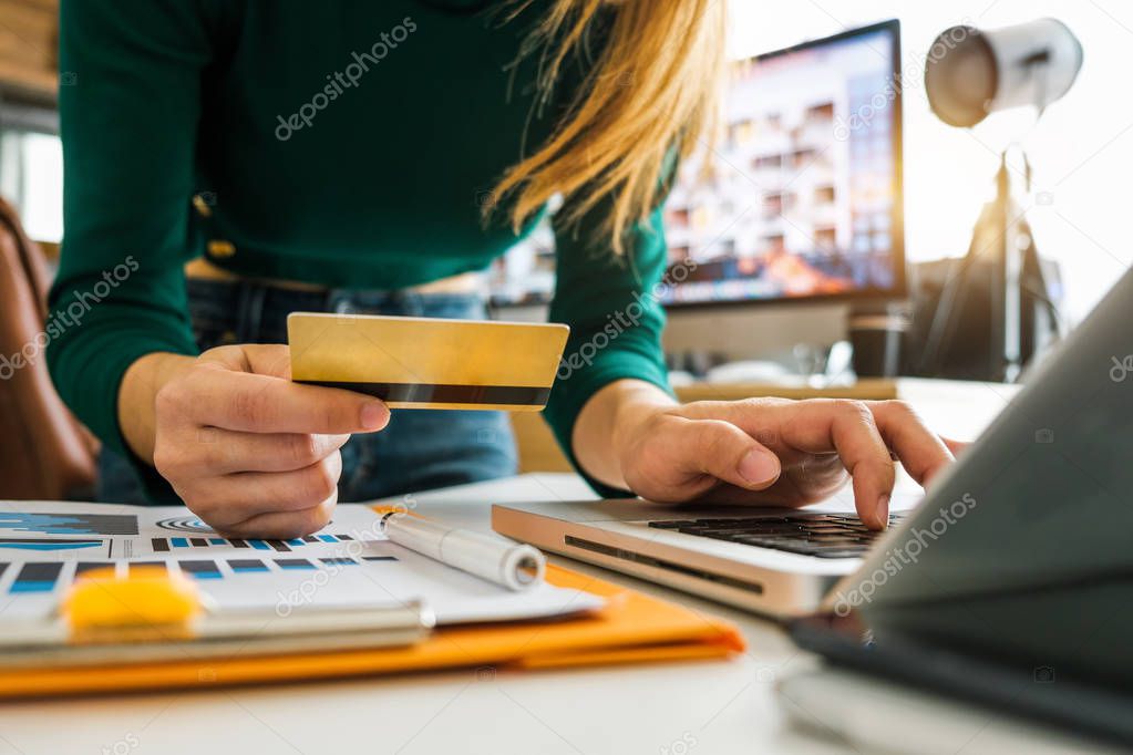Business woman hands using smartphone and holding credit card with digital layer effect diagram as Online shopping concept