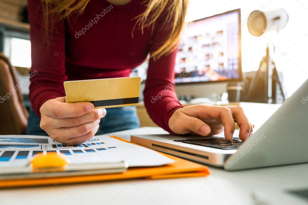 Business woman hands using smartphone and holding credit card with digital layer effect diagram as Online shopping concept